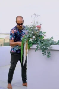 Florist Francois Venter, styling flowers for a wedding in Botrivier